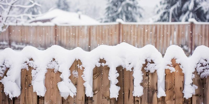 A Wooden Fence Covered in Snow